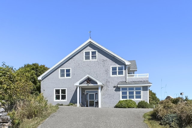 view of front of home with a balcony and driveway