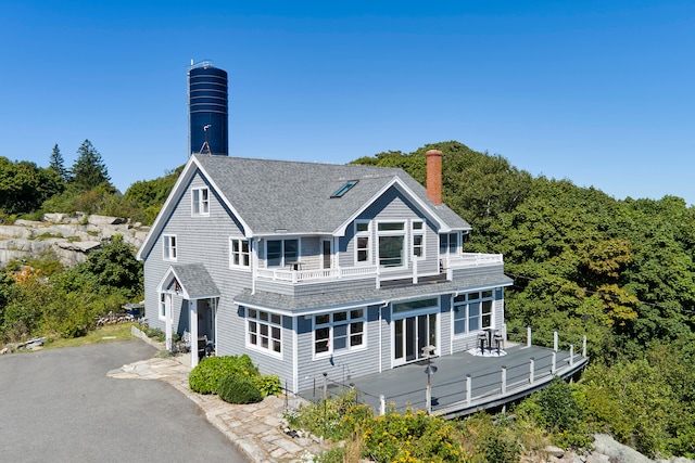 rear view of property featuring a balcony