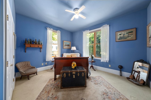 carpeted home office with ceiling fan and a healthy amount of sunlight