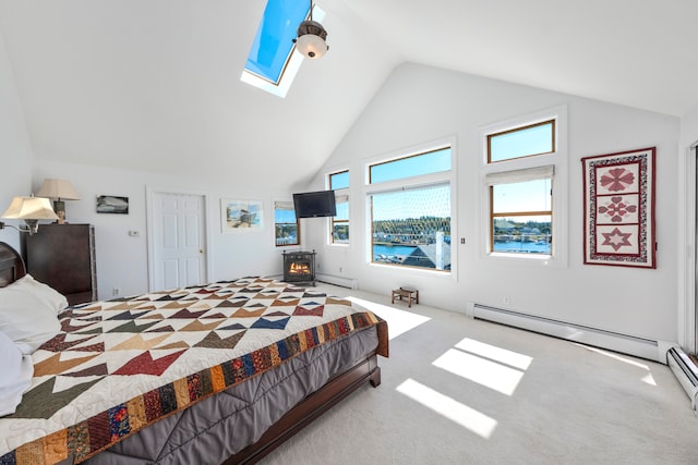 bedroom featuring a baseboard heating unit, light colored carpet, and vaulted ceiling with skylight