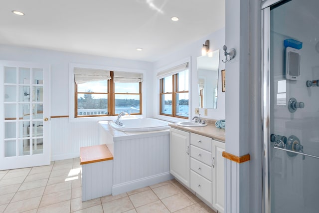 bathroom with tile patterned flooring, shower with separate bathtub, and vanity