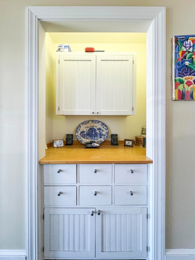 bar with white cabinetry