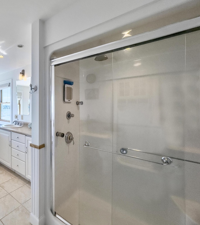 bathroom featuring vanity, tile patterned floors, and a shower stall