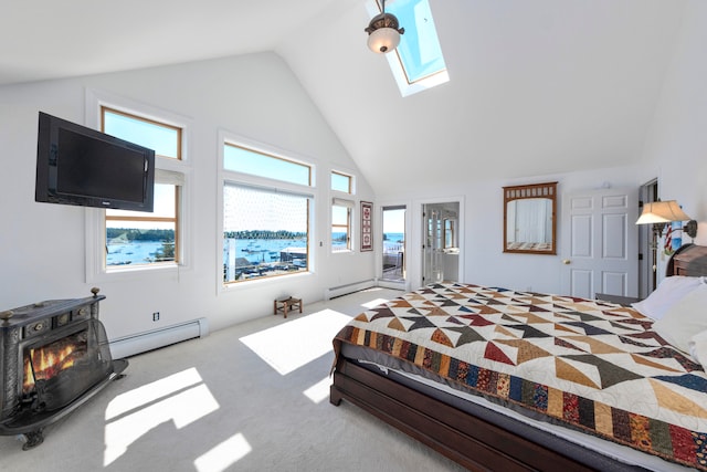 bedroom featuring a skylight, carpet flooring, baseboard heating, a wood stove, and high vaulted ceiling