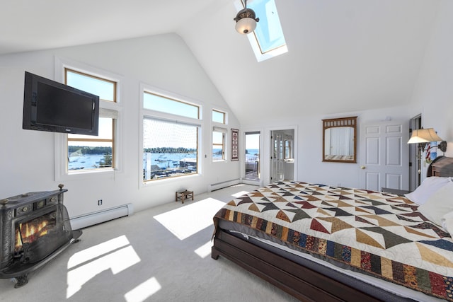 bedroom with a skylight, high vaulted ceiling, a baseboard heating unit, and carpet
