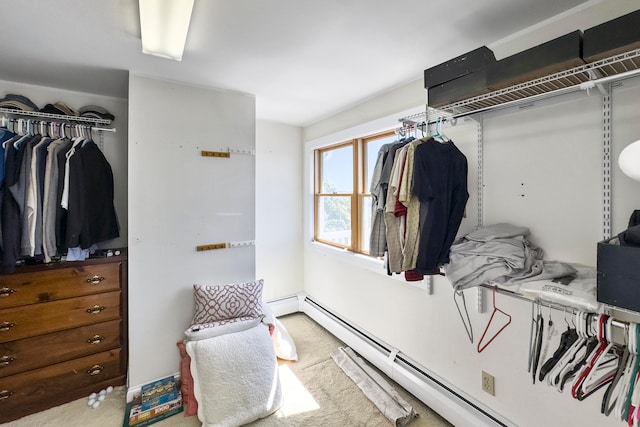 spacious closet featuring carpet flooring and baseboard heating