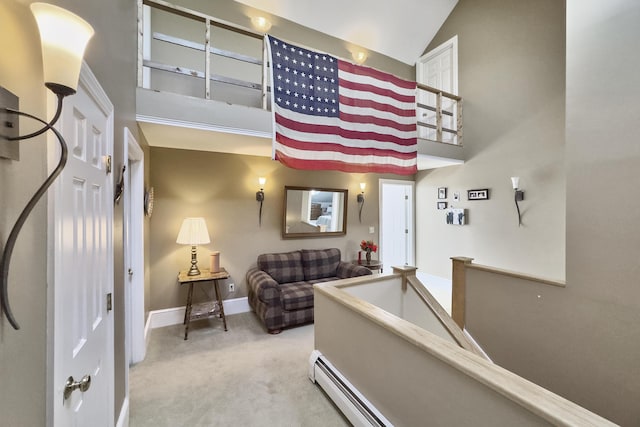 living room featuring carpet flooring, a towering ceiling, and baseboards