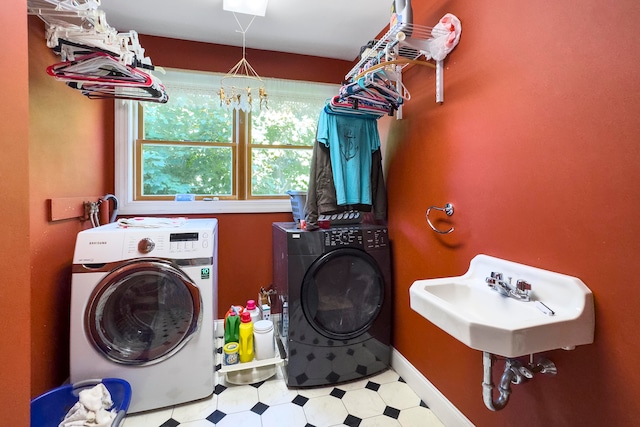 laundry area with washer and clothes dryer and sink