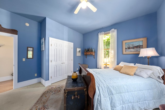 bedroom with connected bathroom, ceiling fan, a closet, vaulted ceiling, and light colored carpet