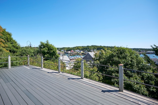 wooden terrace featuring a water view