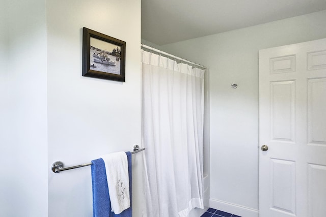 bathroom with baseboards, tile patterned floors, and curtained shower