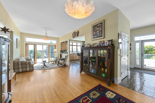 foyer entrance featuring baseboards and wood finished floors