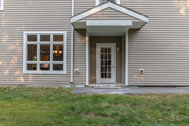 doorway to property featuring a yard