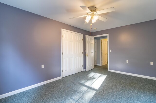 unfurnished bedroom featuring ceiling fan and carpet