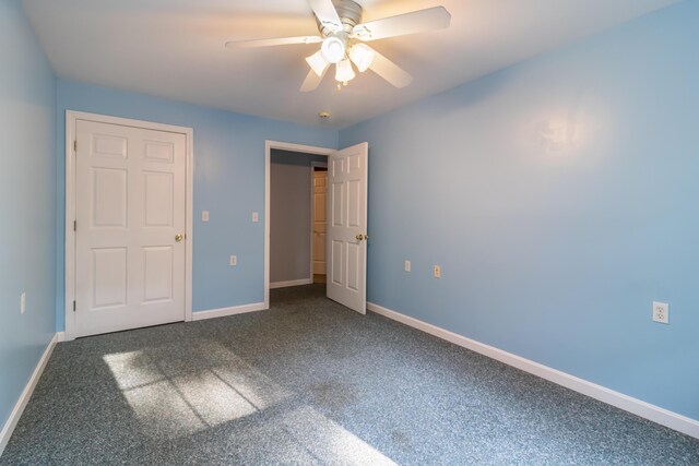 unfurnished bedroom featuring ceiling fan and carpet floors