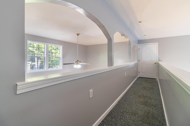 hallway with dark carpet