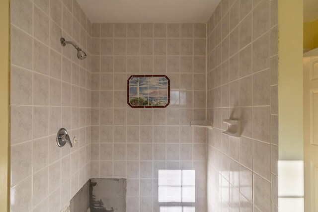 bathroom with a tile shower