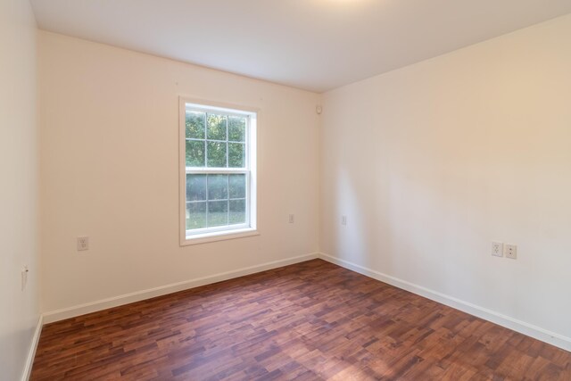 empty room featuring dark hardwood / wood-style floors