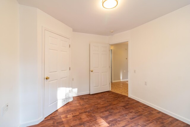 unfurnished room with dark hardwood / wood-style floors