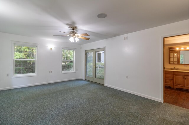 carpeted empty room with ceiling fan and sink