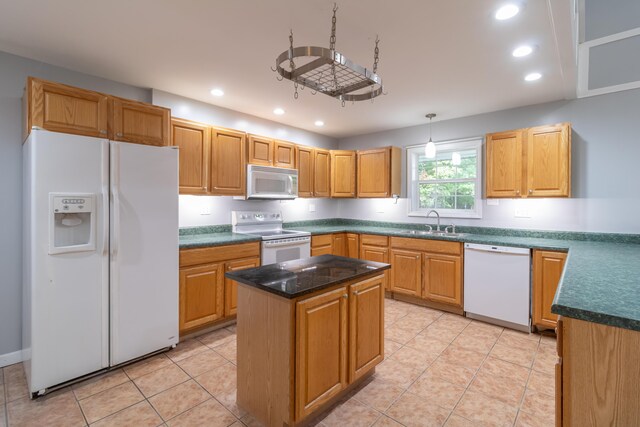 kitchen featuring light tile patterned flooring, sink, pendant lighting, a center island, and white appliances