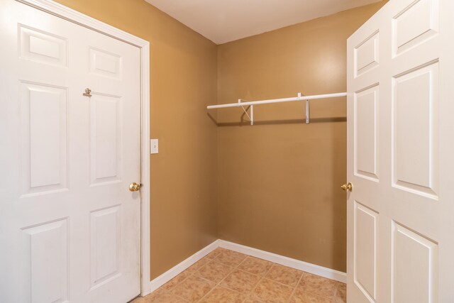 spacious closet with light tile patterned floors