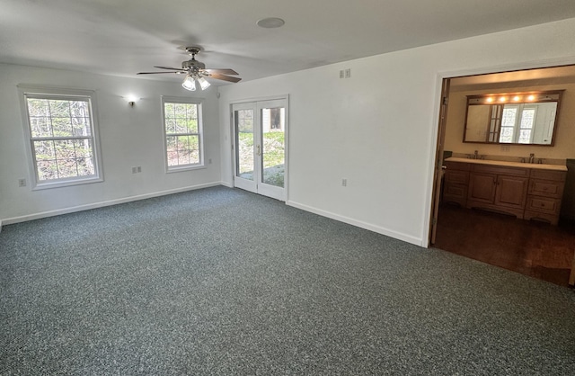 23 Millvale Rd, Bucksport, ME 04416 - empty room featuring a ceiling fan, baseboards, healthy amount of natural light, and dark carpet
