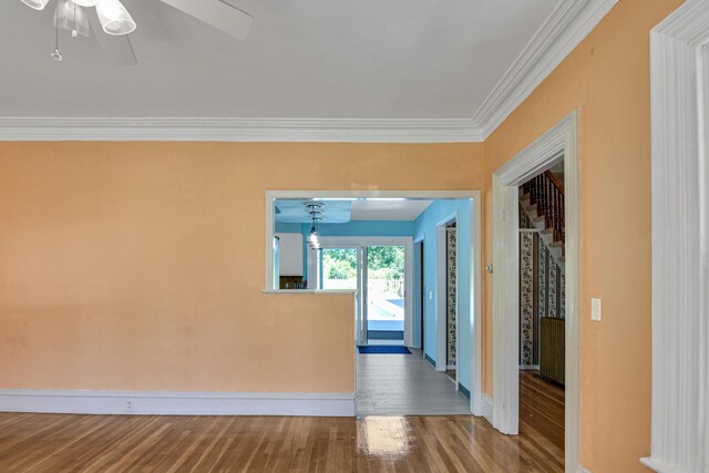 corridor featuring wood-type flooring and crown molding