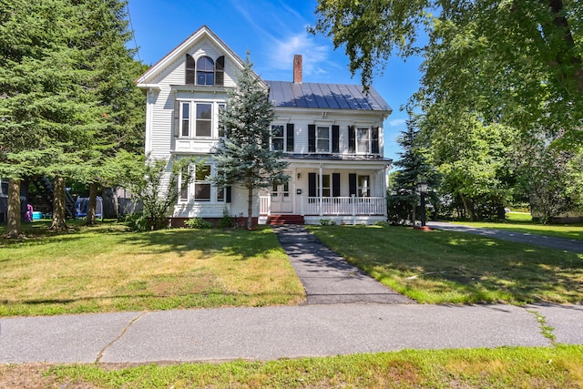 view of front facade featuring covered porch and a front yard