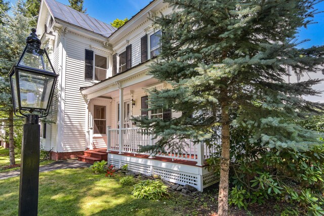 exterior space with a porch and a yard