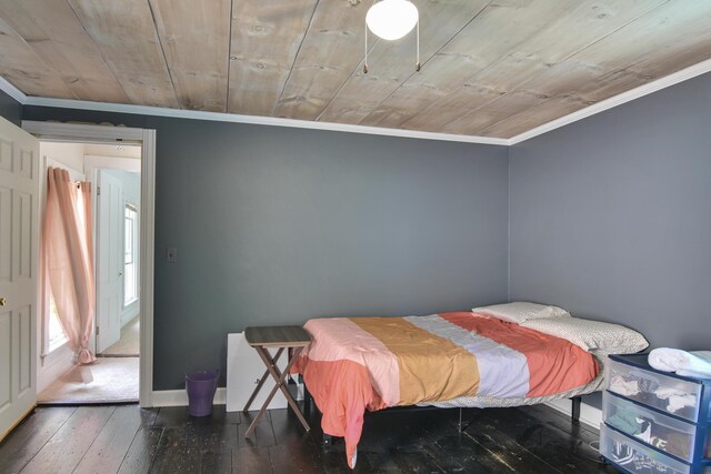 bedroom with ornamental molding, wood ceiling, and dark hardwood / wood-style floors