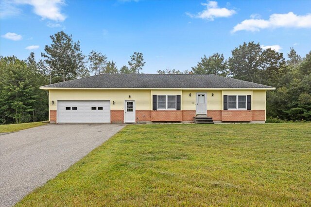 single story home with a front lawn and a garage