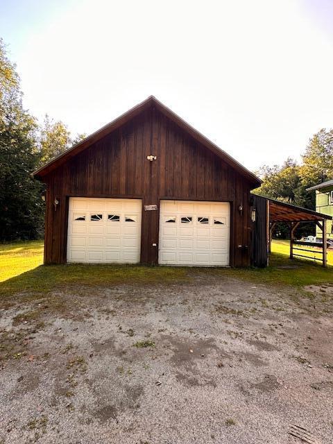 garage featuring wood walls