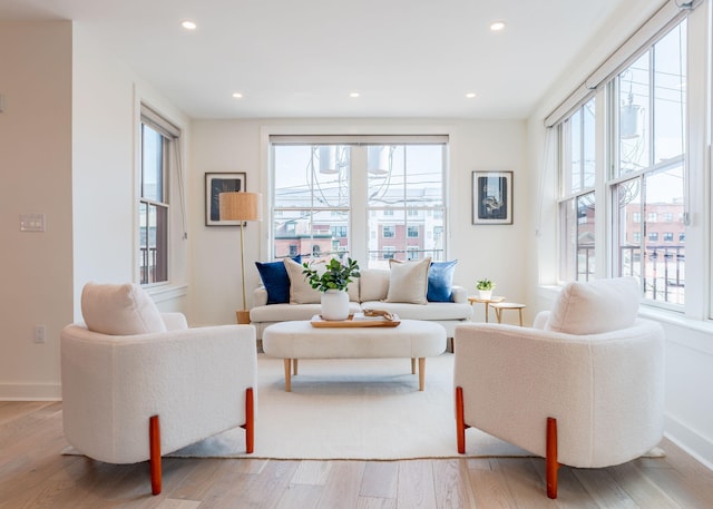 living area with a wealth of natural light, recessed lighting, and light wood finished floors