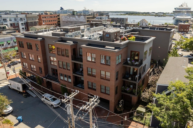 drone / aerial view featuring a view of city and a water view