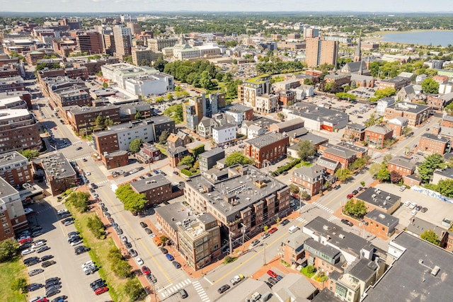 birds eye view of property featuring a water view and a city view