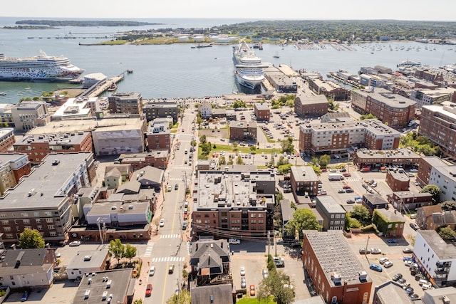 drone / aerial view featuring a water view and a view of city