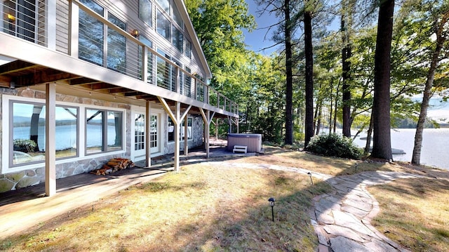 view of yard with a water view and a hot tub