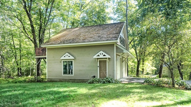 view of outbuilding with a yard