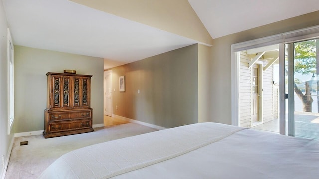 carpeted bedroom featuring access to exterior and lofted ceiling