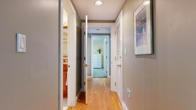 hallway with light hardwood / wood-style floors