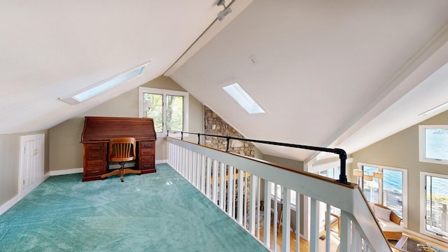 hallway featuring carpet flooring and lofted ceiling