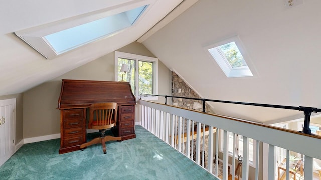 carpeted home office featuring lofted ceiling