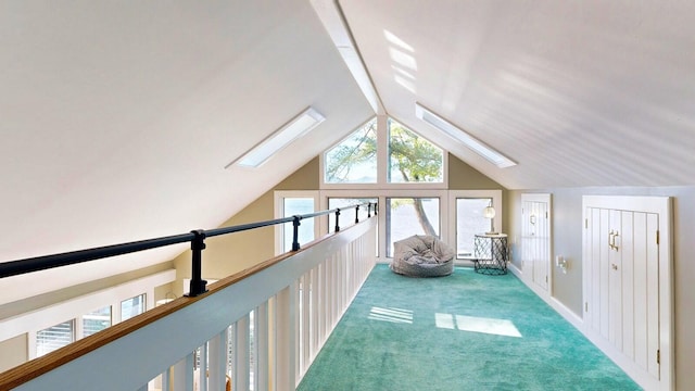 bonus room with carpet and vaulted ceiling with skylight