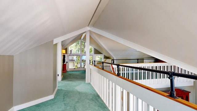 hallway featuring carpet flooring and vaulted ceiling