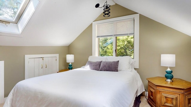 bedroom featuring a closet and vaulted ceiling with skylight