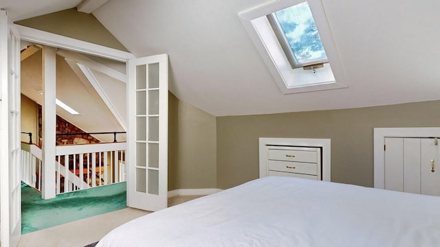 bedroom featuring vaulted ceiling with skylight