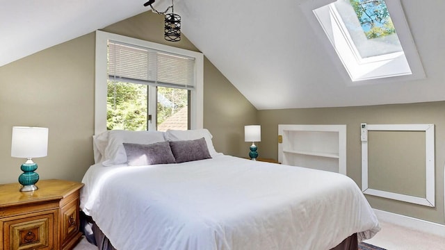 carpeted bedroom featuring vaulted ceiling with skylight