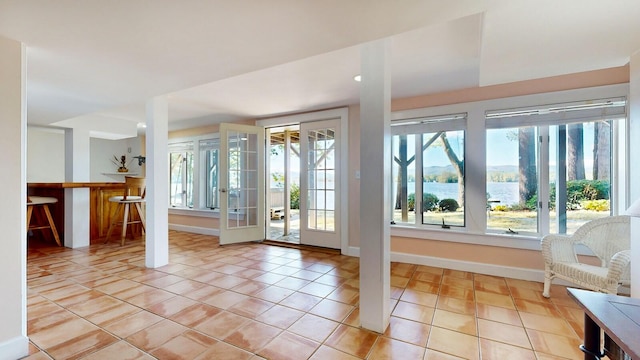 doorway to outside with french doors and light tile patterned floors