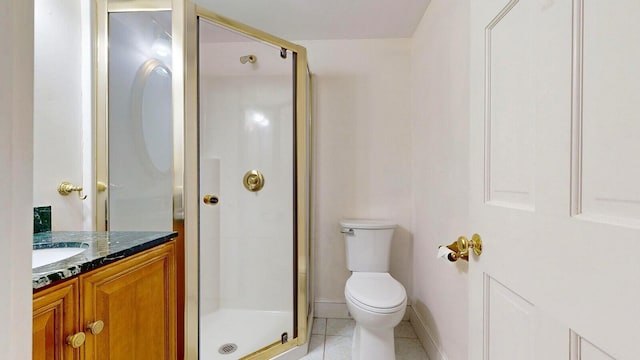 bathroom with tile patterned floors, vanity, toilet, and a shower with shower door